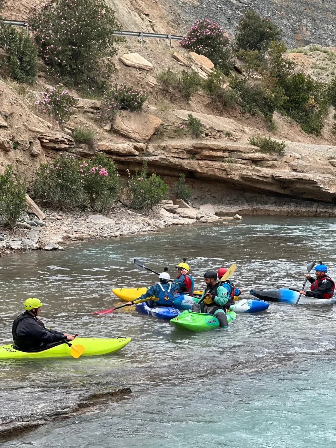 Kayaks and paddlers in moving water
